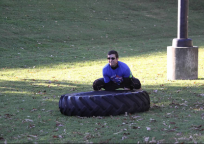 white man flipping tractor tire